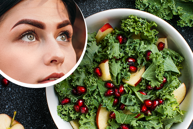 A bowl of kale salad with apple slices and pomegranate seeds, highlighting a woman's glowing skin in a circular inset.