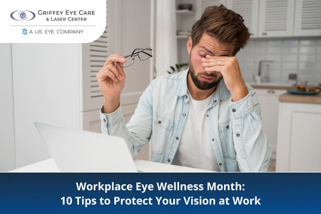 A tired man rubs his eyes while working on a laptop, holding glasses in one hand. Workplace Eye Wellness Month awareness.