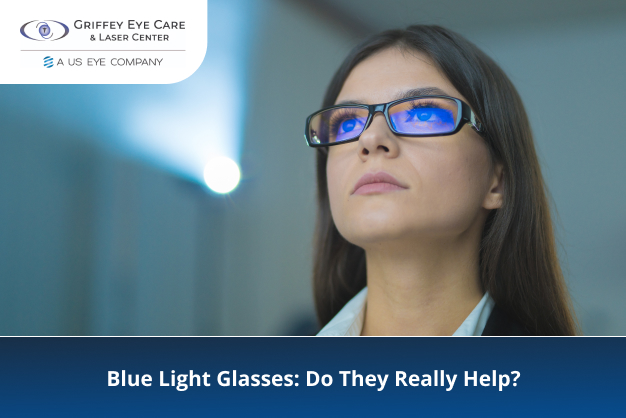 A woman wearing blue light glasses looks at a screen, illustrating eye care and vision protection concepts.