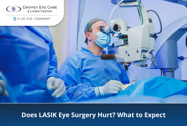 Surgeon in blue scrubs performing LASIK eye surgery using a laser microscope in an operating room.